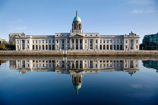 Custom house, Dublin (Ireland) perfectly reflected in the river Liffey on a rare sunny, still day at high tide. This 18th century architectural landmark today houses the Department of Environment, Heritage and Local Government.